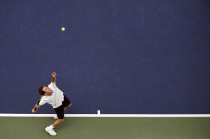 Man Serving Tennis Ball