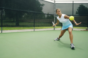 Female Tennis Player Returning Ball