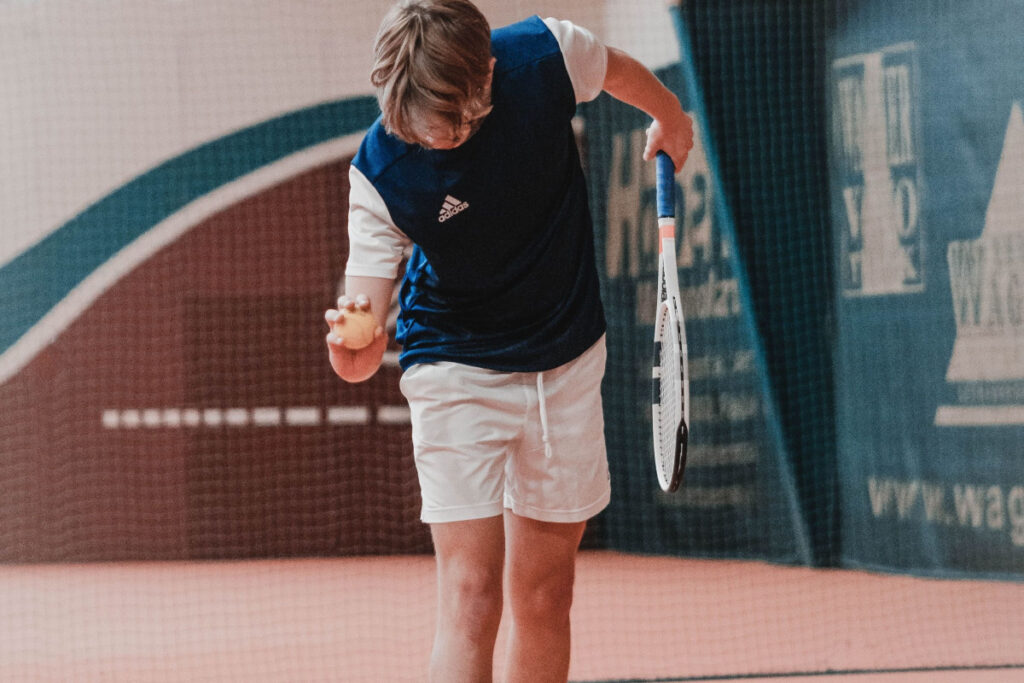 Young tennis player ready to serve